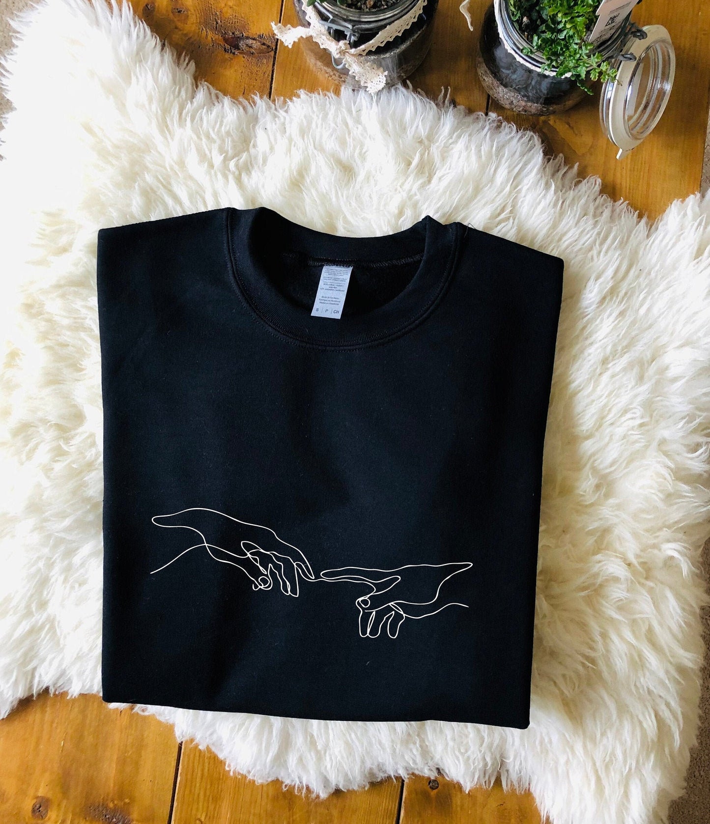 Creation of Adam Black Unisex Sweatshirt with soft fleece-like interior