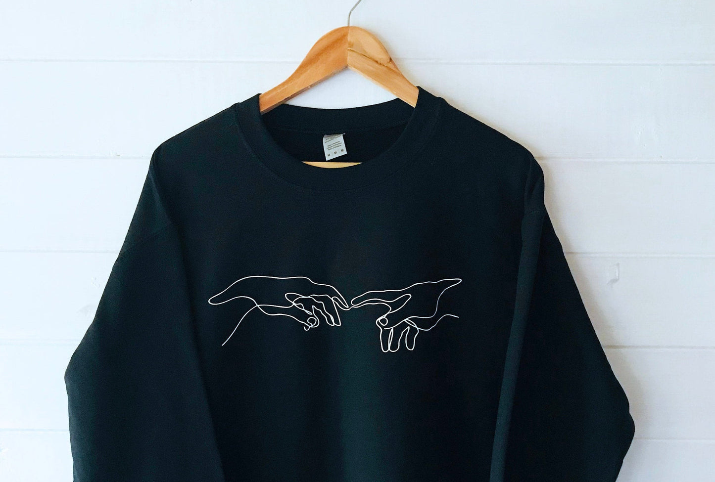 Creation of Adam Black Unisex Sweatshirt with soft fleece-like interior