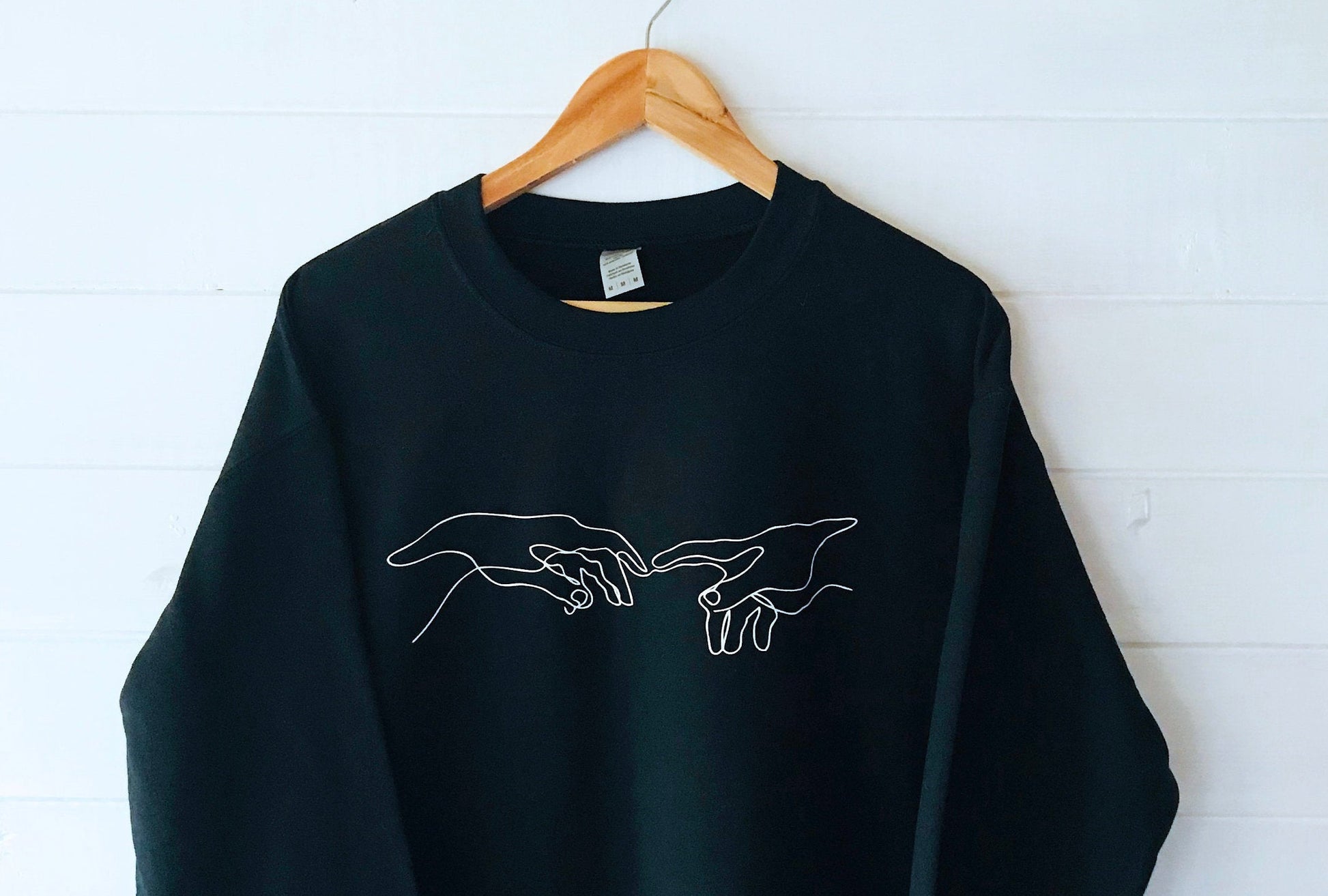 Creation of Adam Black Unisex Sweatshirt with soft fleece-like interior