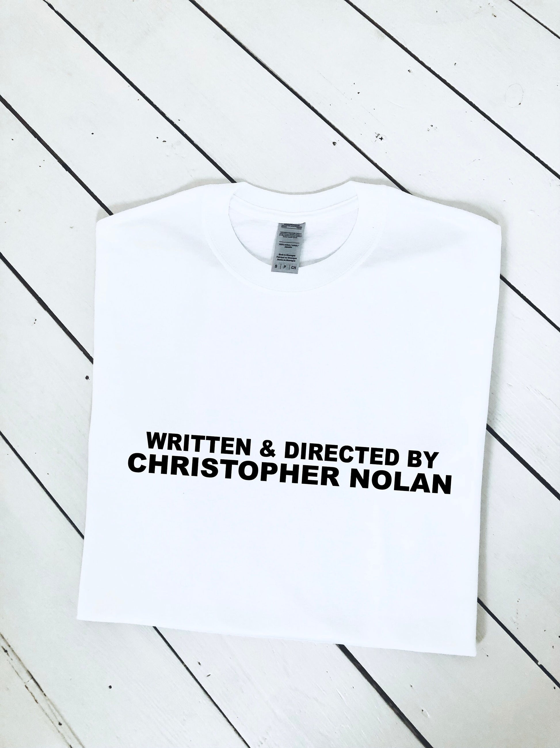 Written and Directed by Christopher Nolan T-shirt, multiple colour tees, mens and womens sizes, movie clothing, movie gift idea